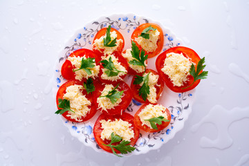 Food. Vegetable sandwiches with tomatoes, grated cheese and herbs. Lay on a plate.
