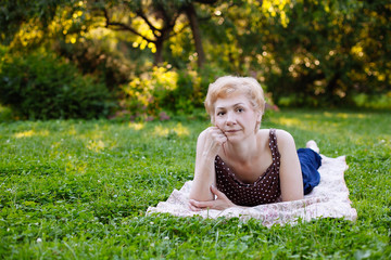 Portrait of middle aged woman smiling in the park