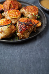chicken pieces with grapefruit slices and spices in the grey bac