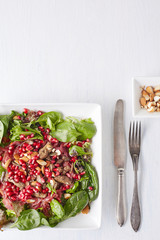 served caramelized liver pieces decorated with pomegranate seeds