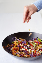 a wok with stir-fried vegetables