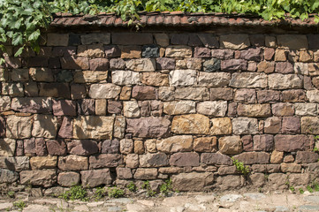 Stone dry masonry wall fence of country house