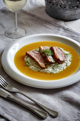 appetizing pieces of smoked duck meat with vegetable puree