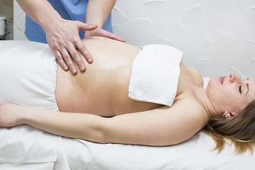 processes salon doing massage to a pregnant woman