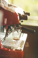 Professional espresso machine pouring strong looking fresh coffe