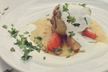 Stuffed peppers - traditional dish for some of the countries in Eastern Europe and Central Asia. Sweet paper stuffed with minced meet, rice and herbs, served with gravy and sour cream