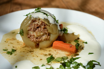 Stuffed peppers - traditional dish for some of the countries in Eastern Europe and Central Asia. Sweet paper stuffed with minced meet, rice and herbs, served with gravy and sour cream.