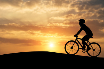 Fototapeta premium Silhouette of a man on muontain-bike, sunset