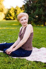 Portrait of middle aged woman smiling in the park