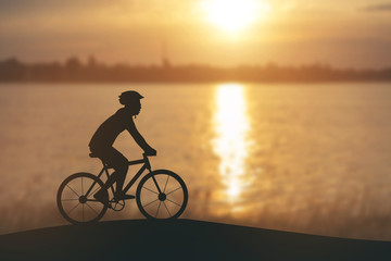 Fototapeta na wymiar Silhouette of a man on muontain-bike, sunset