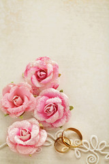 wedding rings and flowers on paper background. wedding invitation