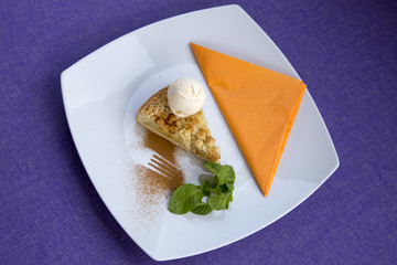 Apple pie dessert decorated with vanilla, mint and cinnamon .