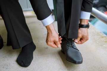 Hands of wedding groom getting ready suit