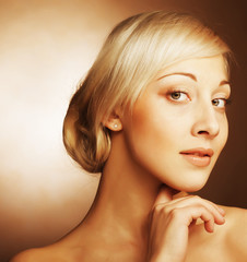  young women with golden hair over beige background