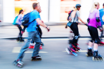 rollerblading people on a city street