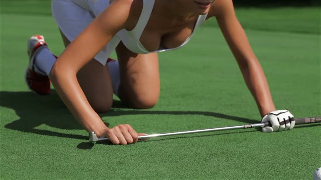 Woman leans on the golf club