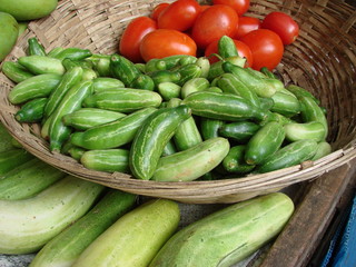 cucumbers and tomatoes in a basket