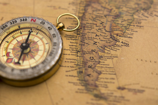 Old compass on vintage map selective focus on Argentina