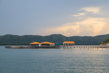 Obraz premium Pier in deep blue sea at sunset