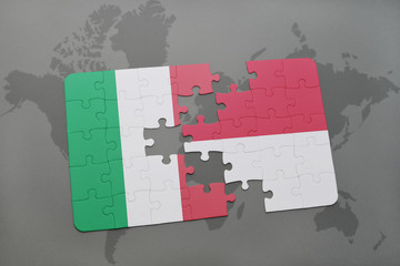 puzzle with the national flag of italy and indonesia on a world map background.