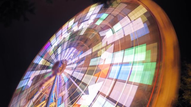 Ferris wheel at an amusement park at night with a slow shutter speed
