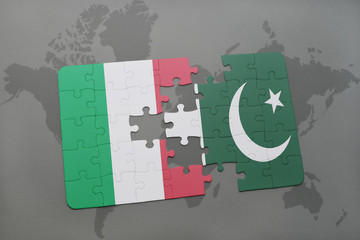 puzzle with the national flag of italy and pakistan on a world map background.