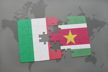 puzzle with the national flag of italy and suriname on a world map background.