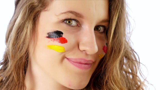 Girl painting her face with German flag