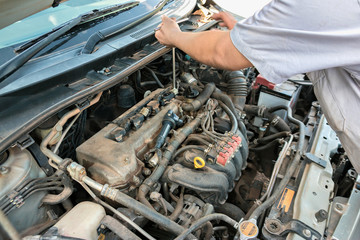 Auto mechanic's hands working on car 
