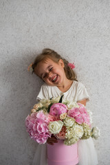 little girl with a big bouquet of fresh flowers