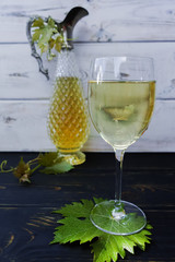 White wine in glass and antique wine pitcher