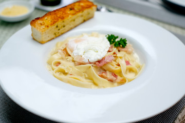 Carbonara Spaghetti  with  bacon and egg on white plate