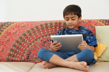 Kid with tablet © DragonImages