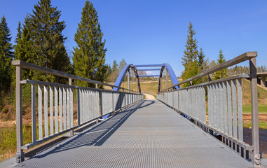 Metal bridge above river.