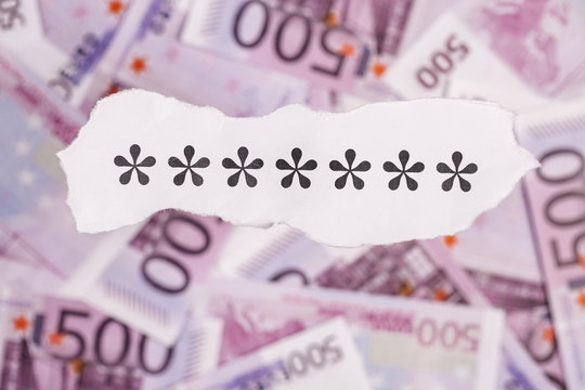 Focus on the symbol ****** on piece of torn white paper with EURO