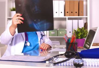 the wife of the doctor at the desk in the office