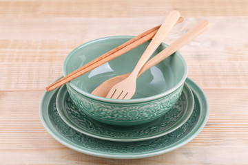 Empty caramic celadon dish with bowl and spoon fork