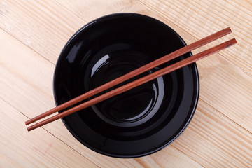 Chopsticks in asian set table on wood background..