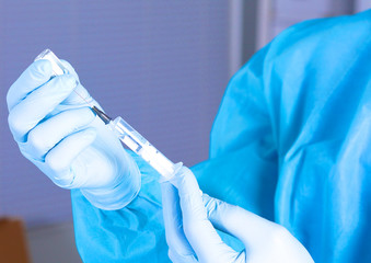 syringe in the hands of the doctor, close-up