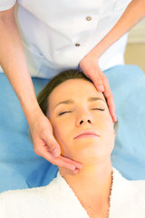Fototapeta na wymiar Detail of a woman face receiving a relaxing facial massage