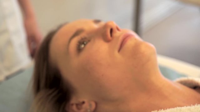 View of a Young attractive masseuse doing a capillariy massage