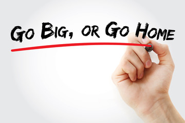 Hand writing Go Big, or Go Home with marker, concept background