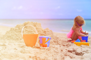 kids toys and little girl building sandcastle