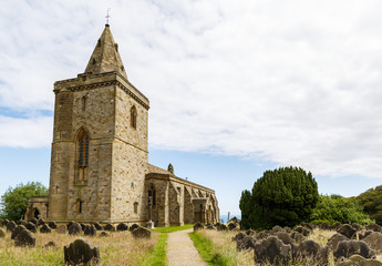 Fototapeta na wymiar LYTHE, ENGLAND - JULY 12: The Church Of St Oswald. In Lythe, North Yorkshire, England. On 12th July 2016.