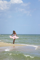 Fototapeta na wymiar happy and beautiful young woman on sea coast