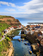 STAITHES, ENGLAND - JULY 12: The classic view of Staithes, from a high viewpoint, showing the beck...