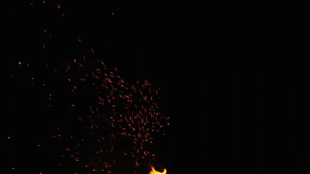 fire sparks from campfire over black background