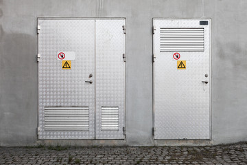 Metal doors with High Voltage warning signs