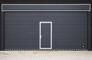 Dark gray modern garage gate with small door