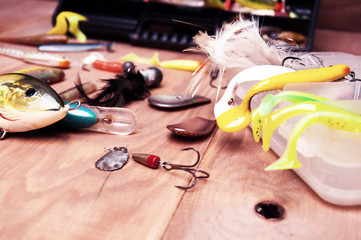 Fishing baits isolated on wooden background